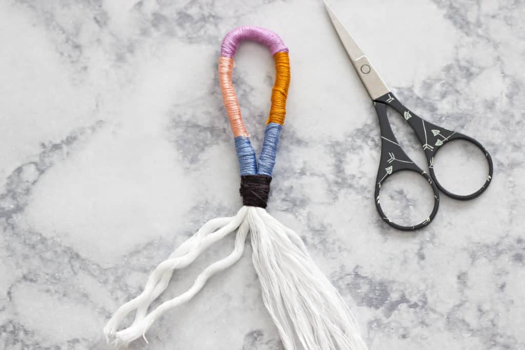 Learn How To Make A Colorful, Fun Rope And Yarn Keychain using regular household items like cotton and embroidery thread. #diy #keychain #howtomake #yarn #kidscrafts