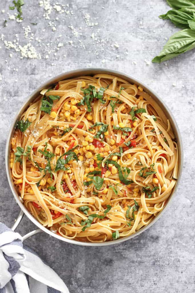 How to make the best Fettuccine with Corn and Tomatoes recipe for a delicious and light summertime meal made with fresh ingredients. #easypastarecipes #easydinnerrecipes #fettuccine #fettuccinewithcornandtomatoes #bestpastarecipes